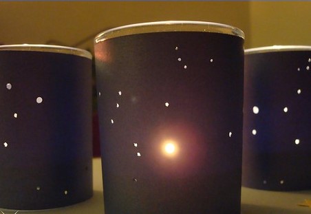Image of constellation luminaries, made from glass votive holders, paper, and flameless electric candles