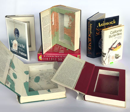 Flat lay of several books cut into book safes