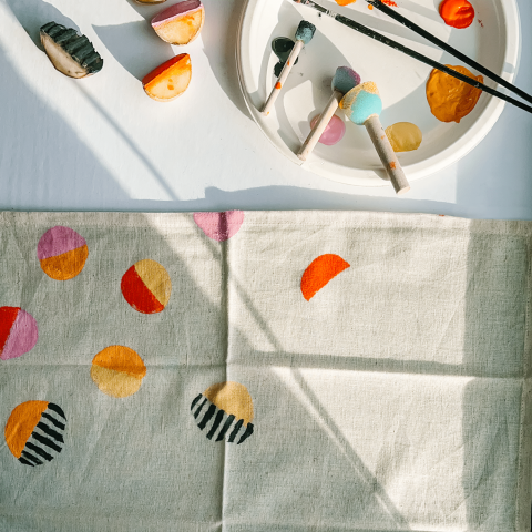 White napkin with color block print patterin in red, orange, and black