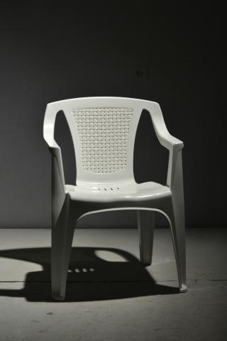 White chair, dark background. 