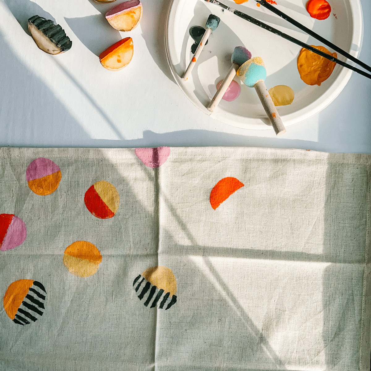 White napkin with color block print patterin in red, orange, and black