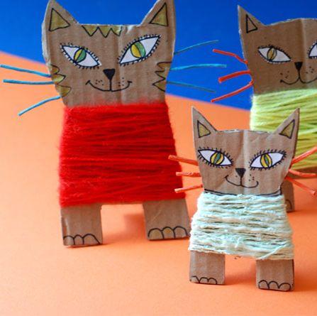 cats wearing yarn sweaters